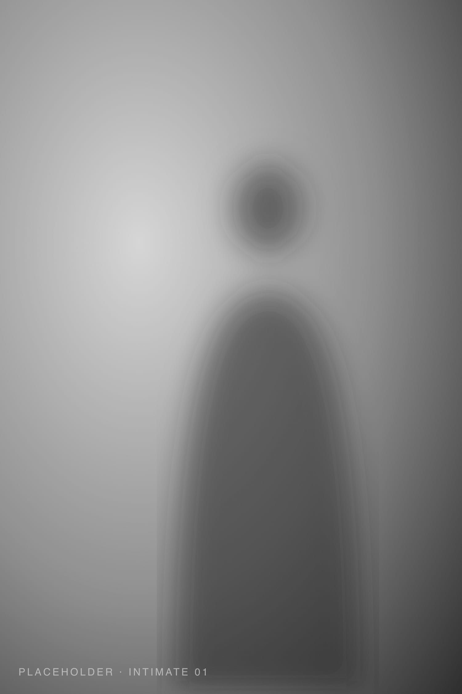 Black and white silhouette of a woman in soft window light
