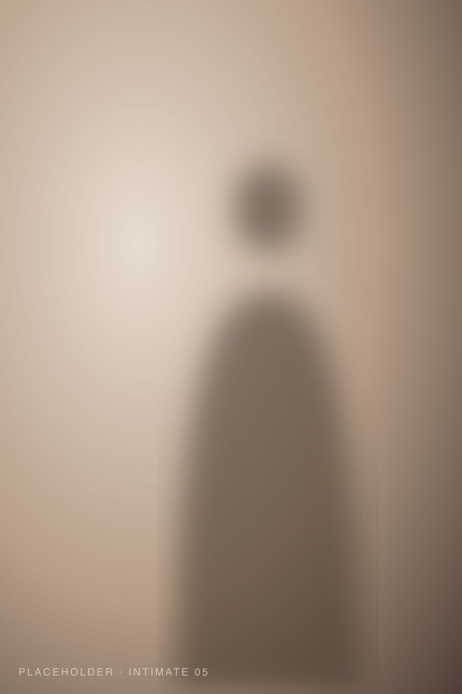 Warm colour portrait with light falling across bare shoulders